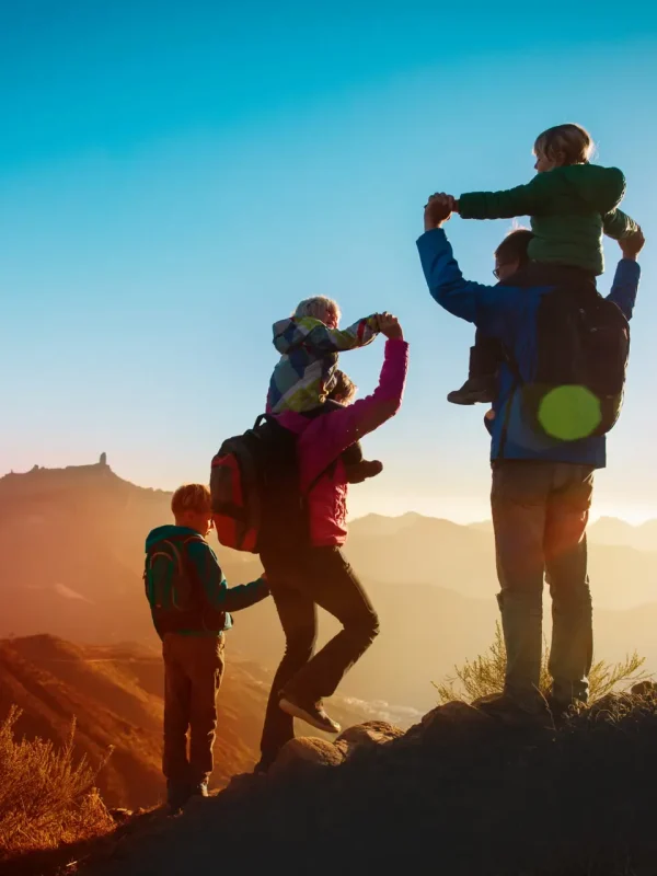 happy family travel in mountains at sunset happy family with kids travel in mountains at sunset