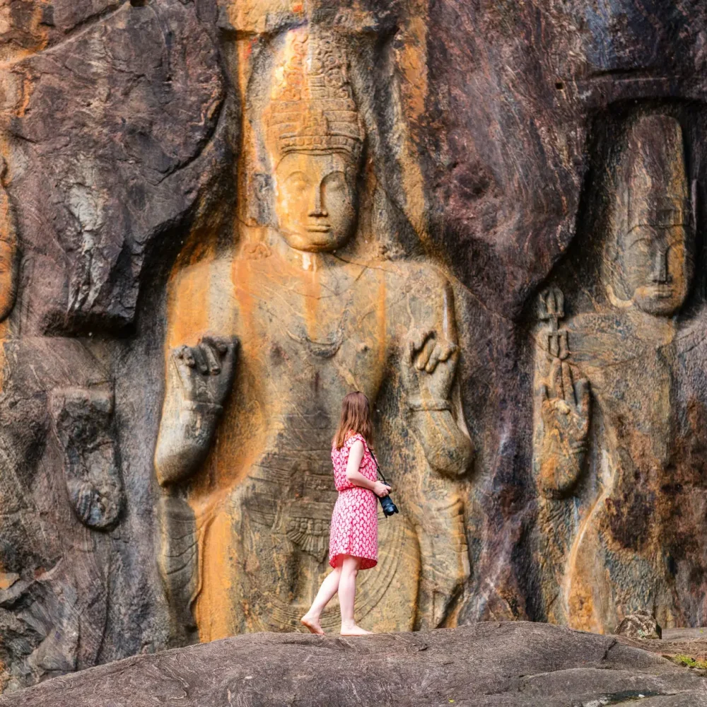 Female tourist at Buduruwagala temple Female tourist visiting Buduruwagala temple with well preserved carvings on the wall in Wellawaya Sri Lanka